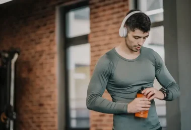 Hombre tomando agua gimnasio